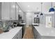 Bright kitchen featuring gray cabinets, stainless steel appliances, and a spacious center island with stylish pendant lighting at 318 Blackrock Ln, Apollo Beach, FL 33572