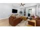 Modern living room with hardwood floors, recessed lighting, ceiling fan and comfortable seating at 318 Blackrock Ln, Apollo Beach, FL 33572