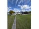 Backyard view showcasing a well-manicured lawn and the home's screen room at 319 Linden Dr, Ellenton, FL 34222