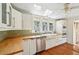 Well-lit kitchen featuring white cabinetry, butcher block countertops, and stainless steel appliances at 330 42Nd S Ave, St Petersburg, FL 33705