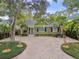 Charming single-story home featuring mature trees, manicured landscaping, and a brick driveway at 3308 W San Nicholas St, Tampa, FL 33629