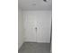 Bright entryway featuring tile flooring and a white front door at 36562 Silver Maize Dr, Dade City, FL 33525