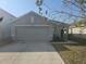 Charming home featuring a two-car garage, well-maintained lawn, and inviting curb appeal at 36562 Silver Maize Dr, Dade City, FL 33525