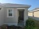 Charming front door surrounded by lush landscaping, creating a welcoming entrance at 36562 Silver Maize Dr, Dade City, FL 33525