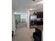 Open floor plan showcasing tile floors and a kitchen area with dark cabinetry at 36562 Silver Maize Dr, Dade City, FL 33525