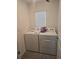 Convenient laundry room featuring a washer and dryer with a window for natural light at 36562 Silver Maize Dr, Dade City, FL 33525