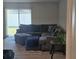 Comfortable living room featuring a large sectional sofa and sliding glass doors to the backyard at 36562 Silver Maize Dr, Dade City, FL 33525