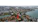 Aerial shot of condo complex with palm trees, near a waterway, and surrounded by a residential area at 406 Sandy Hook Rd, Treasure Island, FL 33706