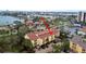 Aerial view shows condo complex in residential area with trees and waterway access at 406 Sandy Hook Rd, Treasure Island, FL 33706