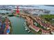Aerial view shows condo complex with waterway access in residential area with other communities at 406 Sandy Hook Rd, Treasure Island, FL 33706