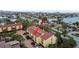 Aerial view shows condo complex in residential area with trees and waterway access at 406 Sandy Hook Rd, Treasure Island, FL 33706