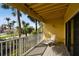 Relax on the private balcony offering serene views of tropical foliage and neighborhood streets at 406 Sandy Hook Rd, Treasure Island, FL 33706
