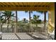Enjoy outdoor living on this cozy balcony, with views of swaying palm trees and manicured landscaping at 406 Sandy Hook Rd, Treasure Island, FL 33706