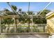This balcony features a painted metal framework and railing with gorgeous views and tropical landscaping at 406 Sandy Hook Rd, Treasure Island, FL 33706