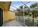 Balcony with metal framework overlooks lush landscaping and features a gray wood deck floor at 406 Sandy Hook Rd, Treasure Island, FL 33706