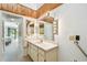 A bright bathroom features a white vanity and access to a balcony at 406 Sandy Hook Rd, Treasure Island, FL 33706