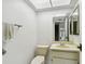 Half bathroom featuring a toilet, sink, vanity, and neutral colors at 406 Sandy Hook Rd, Treasure Island, FL 33706