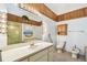 White bathroom with wood trim and a white vanity, toilet, and bidet at 406 Sandy Hook Rd, Treasure Island, FL 33706