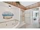 This bathroom features a large garden tub, stand-up shower, and access to the main bedroom at 406 Sandy Hook Rd, Treasure Island, FL 33706