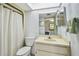 Bathroom with a skylight, shower with curtain, single sink and neutral decor at 406 Sandy Hook Rd, Treasure Island, FL 33706