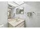 Bathroom features a skylight, neutral walls, single sink, and large mirror at 406 Sandy Hook Rd, Treasure Island, FL 33706