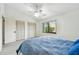 Bright bedroom offers a ceiling fan, carpeted floor, and double closets at 406 Sandy Hook Rd, Treasure Island, FL 33706