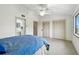 Open bedroom showcasing ensuite bath, double closets, and a bright window at 406 Sandy Hook Rd, Treasure Island, FL 33706