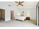 Bedroom features light walls, ceiling fan, and double closets at 406 Sandy Hook Rd, Treasure Island, FL 33706