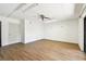 Bright bonus room with new wood floors, a ceiling fan, and multiple lighting fixtures at 406 Sandy Hook Rd, Treasure Island, FL 33706