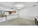 Cozy dining area adjacent to the kitchen features a modern chandelier and ample natural light at 406 Sandy Hook Rd, Treasure Island, FL 33706