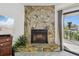 The stunning stone fireplace is the focal point of the living room, complemented by a sliding glass door at 406 Sandy Hook Rd, Treasure Island, FL 33706