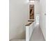 Bright hallway featuring wood trim, carpeted floors, and artwork at 406 Sandy Hook Rd, Treasure Island, FL 33706