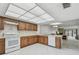 Bright kitchen features white appliances, tile floors, and wood cabinets in a spacious open layout at 406 Sandy Hook Rd, Treasure Island, FL 33706