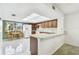Well-lit kitchen includes a breakfast nook, ample cabinet space, and modern appliances at 406 Sandy Hook Rd, Treasure Island, FL 33706