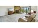 Open living room with carpet, a stone fireplace, and sliding glass doors to a balcony with stunning views at 406 Sandy Hook Rd, Treasure Island, FL 33706