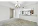 Bright living room is connected to the kitchen with neutral tones, and modern lighting at 406 Sandy Hook Rd, Treasure Island, FL 33706