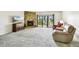 Open living room with carpet, a stone fireplace, and sliding glass doors to a balcony with stunning views at 406 Sandy Hook Rd, Treasure Island, FL 33706