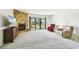 Bright living room features a stone fireplace, plush carpet, and sliding glass doors to the outside at 406 Sandy Hook Rd, Treasure Island, FL 33706