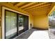 Exterior view of covered patio with sliding glass doors, offering a seamless transition between indoor and outdoor living at 406 Sandy Hook Rd, Treasure Island, FL 33706