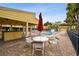 Outdoor community area featuring brick pavers, a covered pavilion with outdoor bar, and ample lounge seating by the pool at 406 Sandy Hook Rd, Treasure Island, FL 33706