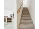 Carpeted staircase featuring wood railing at 406 Sandy Hook Rd, Treasure Island, FL 33706