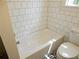 Bright bathroom featuring a white tub with tiled walls and a modern toilet at 456 9Th N Ave, St Petersburg, FL 33701