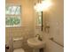 Charming bathroom features a pedestal sink and classic tile work around the window at 456 9Th N Ave, St Petersburg, FL 33701