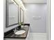 Bathroom features dual sinks, granite countertops, framed mirrors, and updated fixtures at 5014 W Lancaster St, Tampa, FL 33616
