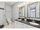 Bathroom featuring a double vanity sink, modern fixtures, and sleek shower design at 5014 W Lancaster St, Tampa, FL 33616