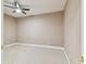 Cozy bedroom with neutral walls, plush carpeting, and a modern ceiling fan at 5014 W Lancaster St, Tampa, FL 33616