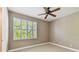 Bedroom with a window with plantation shutters and a ceiling fan at 5014 W Lancaster St, Tampa, FL 33616