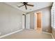 Bedroom showing a closet and another doorway, ceiling fan and a window with plantation shutters at 5014 W Lancaster St, Tampa, FL 33616