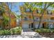 Charming townhome featuring a private garage, front balcony, and well-maintained landscaping at 5014 W Lancaster St, Tampa, FL 33616