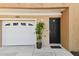 Welcoming front entrance featuring a one-car garage and a beautifully decorated front door at 5014 W Lancaster St, Tampa, FL 33616